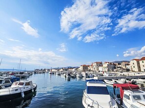 A marina with boats docked, a clear sky, and buildings in the background. - Apartment Ružica by Interhome (Kaštela)