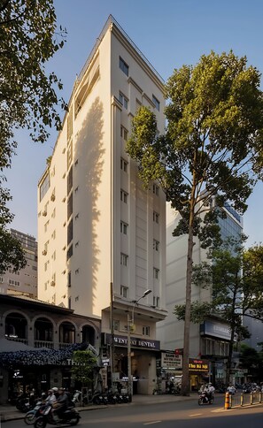 A multi-story building with a prominent sign for 'West Way Dental' on the ground floor. - Asian Ruby Hotel & Apartment (Ho Chi Minh City)