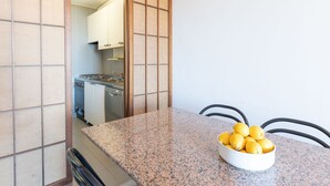 A kitchen with a granite countertop and a bowl of lemons. - I Boboli by Interhome (Punta Ala)