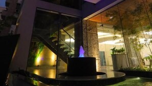 A modern building with a pool area, glass walls, and a staircase. - Pearl Hotel Dhaka (Dhaka)