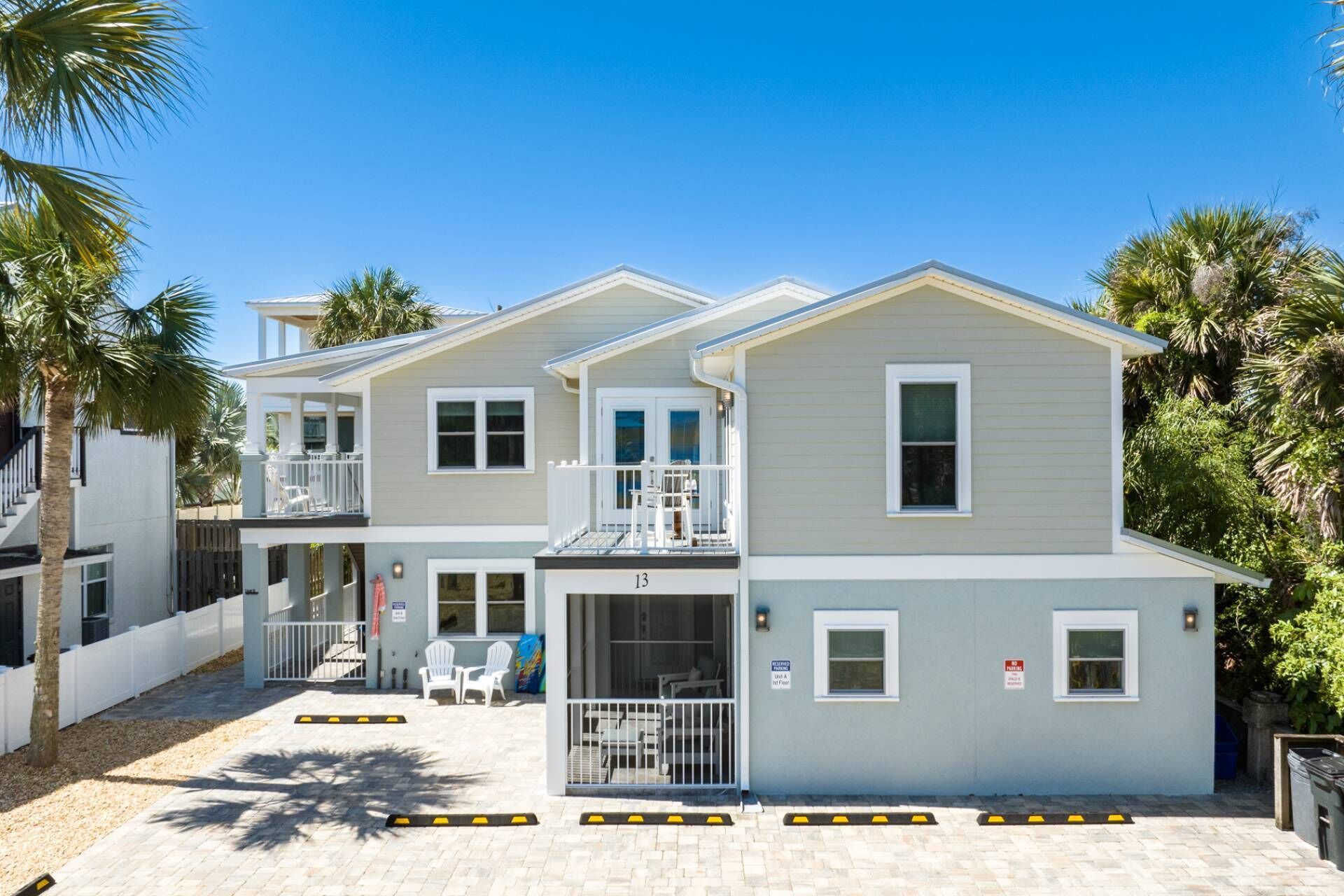 A two-story building with a balcony and a covered outdoor seating area.