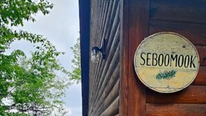 A wooden cabin with a sign reading "SEBOOOMOOK" and a wooden deck leading to it. - Seboomook-Lake/Mountain Views*Shared Dock*Kayaks*Hiking Trails*A/C (Greenville)