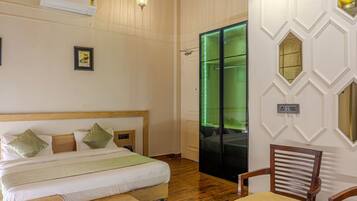 A bedroom with a wooden bed, a chair, and a green-lit door.