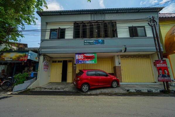 Stylish two-story building with a commercial ground floor and a prominent entrance.