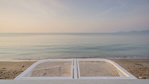 A beach view with a white metal railing and a clear sky. - Aadhitiya Private Pool Villas (Tha Mai)