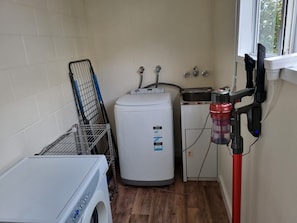 A laundry area with a washing machine, a dryer, and a water heater.