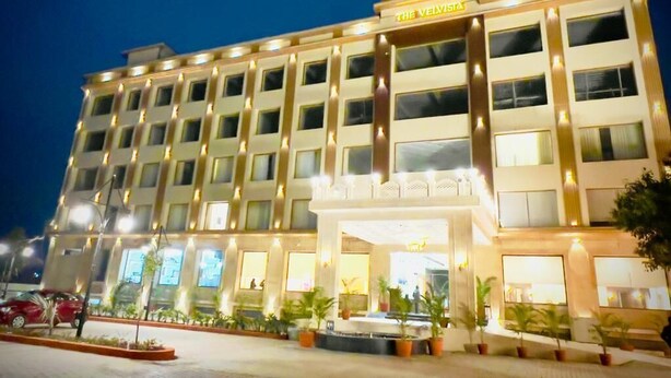 A multi-story hotel with a prominent entrance and a sign reading "The Velvista." - The Velvista Hotel (Muzaffarnagar)