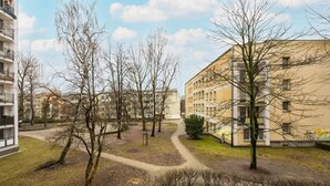 A residential area with apartment buildings, bare trees, and a winding path. - Comfortable Apartment | Balcony | Close to the Center (Warszawa)