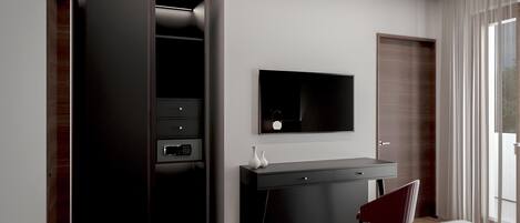 Un dormitorio moderno con cama, escritorio, televisor y armario.