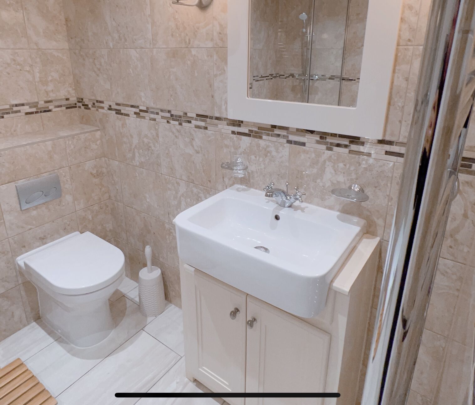 Une salle de bain avec des toilettes, un lavabo et une douche.