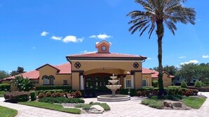 A building with a clock tower, a fountain, and a palm tree in the foreground. - Spacious And Relaxing Home With South Facing Pool 6 Bedroom Home by RedAwning (Davenport)