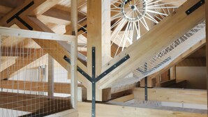 A wooden interior with a sloped ceiling, a skylight, and a patterned floor. - casa Rosa milo (Milo)