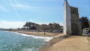 A coastal scene with a tall monument, beach, and parked cars. - Stunning property and location with fabulous views overlooking Wootton Creek. (Wootton Bridge)