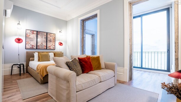 A modern bedroom with a bed, a sofa, and a large window. - Sta. Catarina 632 - 2T by LovelyStay (Porto)