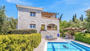 A stone building with a swimming pool, lounge chairs, and a pergola. - Villa Epavlis - Three Bedroom Villa, Sleeps 6 (Pilos Nestor)