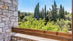 A stone wall with a wooden bench overlooking a lush landscape with trees and shrubs. - Villa Epavlis - Three Bedroom Villa, Sleeps 6 (Pilos Nestor)