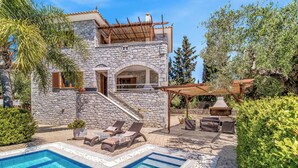 A stone house with a swimming pool, outdoor seating, and a pergola. - Villa Petra - Two Bedroom Villa, Sleeps 4 (Pilos Nestor)
