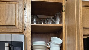 A kitchen with wooden cabinets, a microwave, and a utensil holder. -  1 bdrm condo. Indoor parking garage. Secure bldg access.  90 day minimum stay (Anchorage)