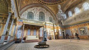 An ornate interior with a central fountain, columns, and a chandelier. - Iris Han Hotel (Istanbul)