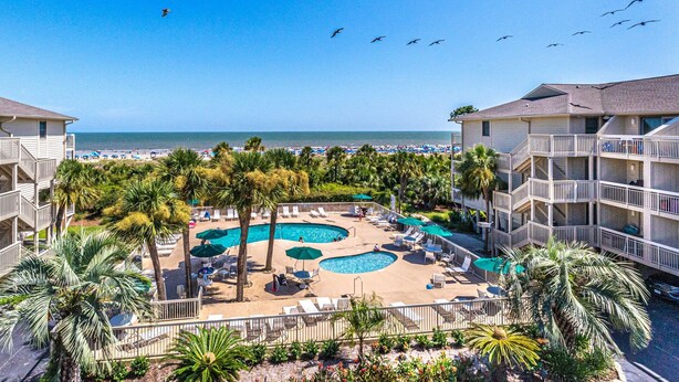 A resort with multiple swimming pools, palm trees, and a beach view. - 321 Oceanfront Villa | Walk to Coligny + Pools | Washer/Dryer (Hilton Head Island)