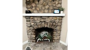 A stone fireplace with a white mantel shelf and a small potted plant. - Entire Home N. Conway - Central Location, Saco, Skiing, Shopping (Conway)