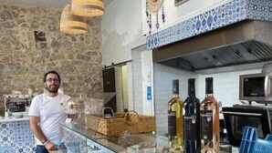 A deli counter with various meats and cheeses, a person standing behind it, and decorative wall elements. - 1 Bedroom : Scandinavian Urban 4 in city center (Cannes)