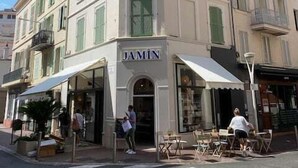 A corner building with a storefront labeled "JAMIN". - 1 Bedroom : Scandinavian Urban 4 in city center (Cannes)