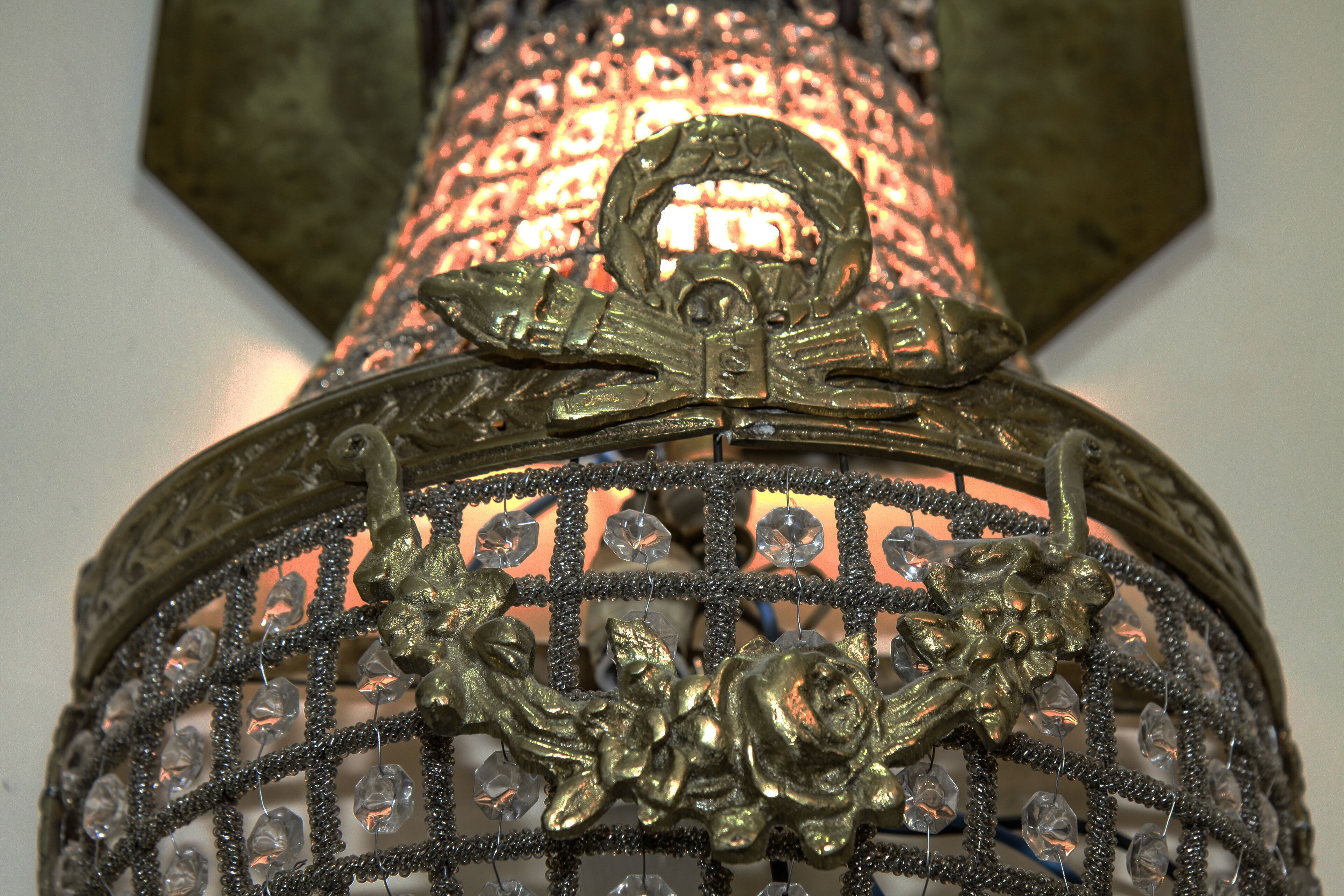 A close-up of an ornate metal structure with intricate designs and embedded crystals.