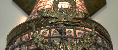 A close-up of an ornate metal structure with intricate designs and embedded crystals.