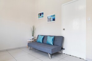 Elegant Living Area of the Apartment in Nood Aruba - Smart TV and Netflix - Comfy Sofa - Harmonious color scheme with pops of accent colors for visual interest - Aruba 1BR Apartment w Free Parking near Palm Beach (Noord)