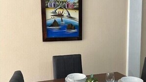 A dining table set with plates, glasses, and a decorative centerpiece.