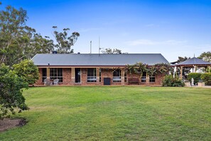 A brick building with a flat roof, large windows, and a small porch area.
