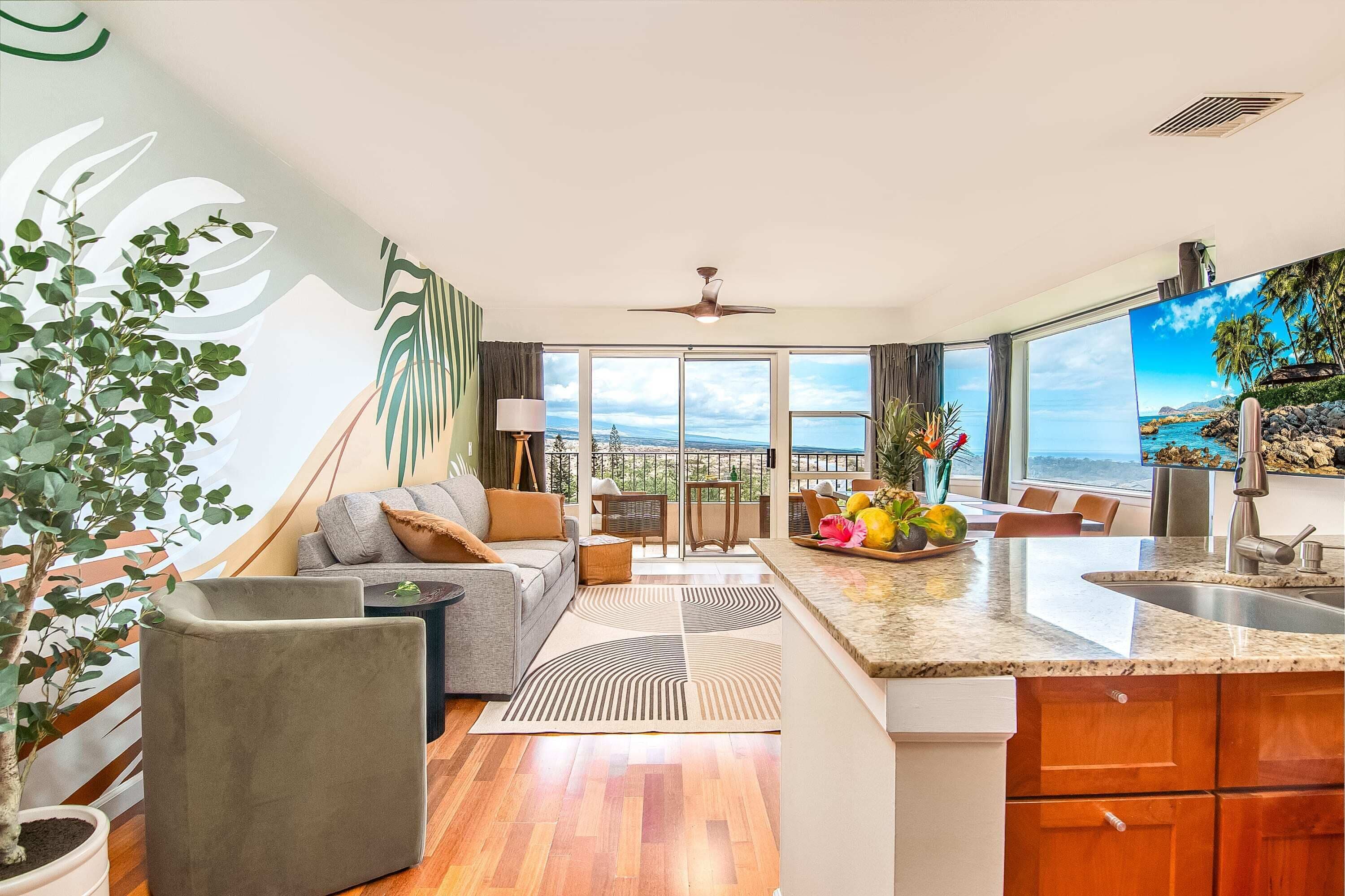 A modern living room with a sofa, coffee table, and a view of the ocean.