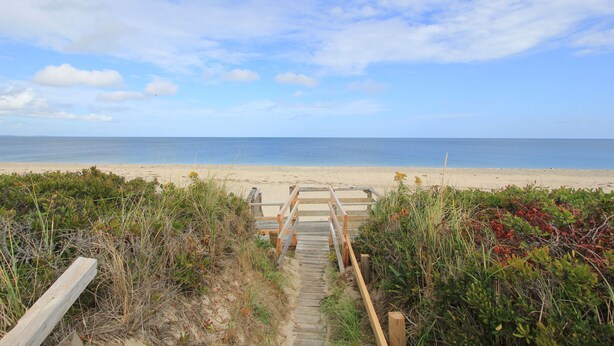 A wooden pathway leading to a beach with a clear view of the ocean. - 36 Salt Marsh Rd (Sandwich)