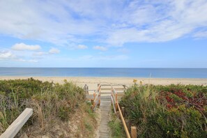 A wooden pathway leading to a beach with a clear view of the ocean. - 36 Salt Marsh Rd (Sandwich)