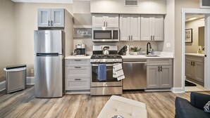 A modern kitchen with stainless steel appliances, a built-in microwave, and a gas stove. - Perfetto North End 1brm  (Boston)