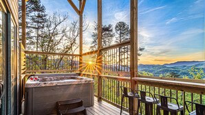 A wooden deck with a hot tub and bar seating overlooking a mountainous landscape. - Unbelievable VIEWS indoor pool cabin (Sevierville)