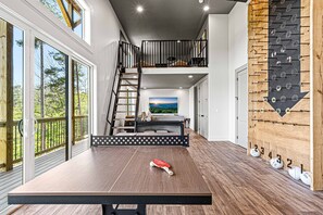 Relax and play in this spacious room featuring a ping pong table and functional storage.