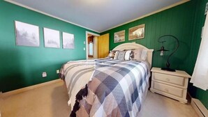 A bedroom with a bed, nightstands, and artwork on the walls. - 8 Powderidge, Snowshoe, WV - Slopeside Sanctuary (Snowshoe)