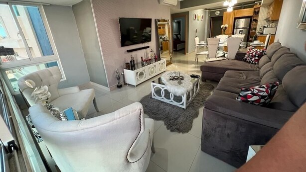 A modern living room with a sofa, armchairs, a coffee table, and a TV. - Luxury & Secure-Santo Domingo Este-Close & Safe-Weekly Discounts (Santo Domingo Este)