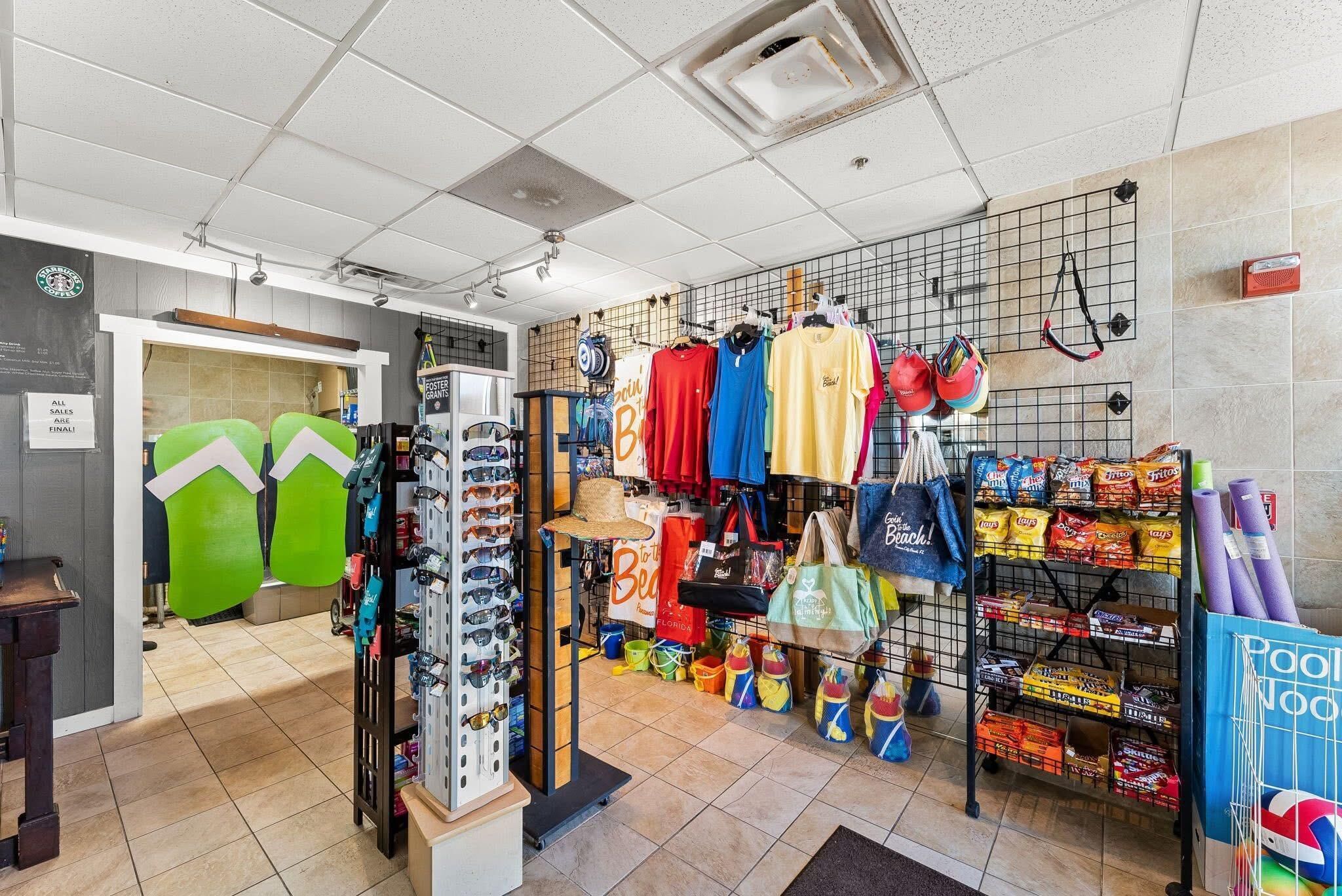 A retail store with various items on display, including clothing, bags, and snacks.