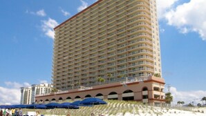 A high-rise hotel with multiple balconies, a flat roof, and a beachfront location. - Sunrise Beach 2411 (Panama City Beach)