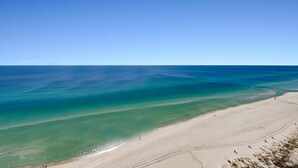 A beach with clear turquoise waters and a sandy shore. - Sunrise Beach 2411 (Panama City Beach)