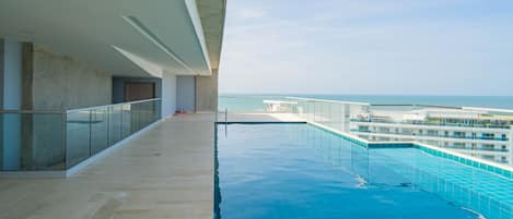 Outdoor pool, open 8:00 AM to noon, pool umbrellas, lifeguards on site