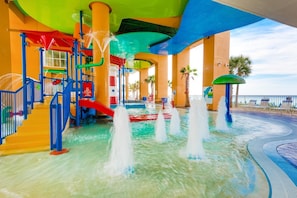 A water park with slides, a pool, and a beach area. - Splash 1102e (Panama City Beach)
