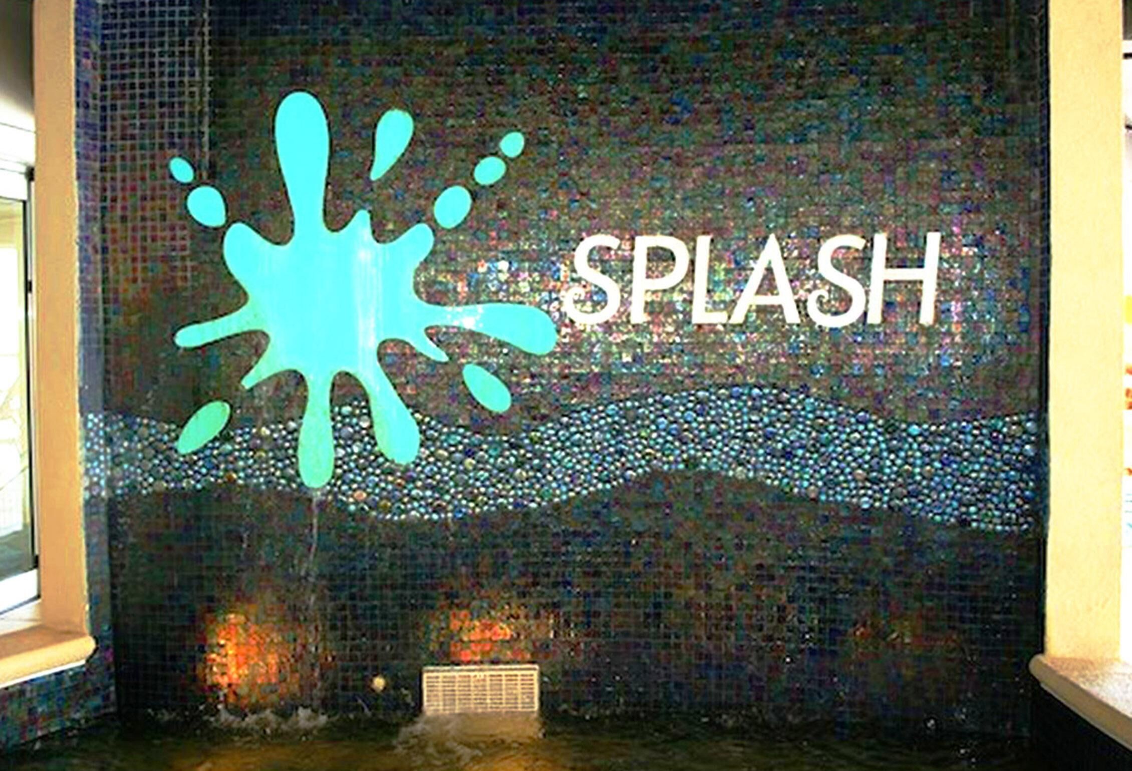 A mosaic wall with the word "SPLASH" and a splash design.