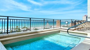 A pool with a view of the beach and ocean, surrounded by a black metal fence and a sign indicating 'No Swimming'. - Origin at Seahaven 825 (Panama City Beach)
