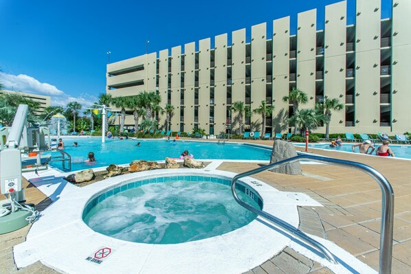 Relax by the pool surrounded by lush palm trees and enjoy the hot tub.