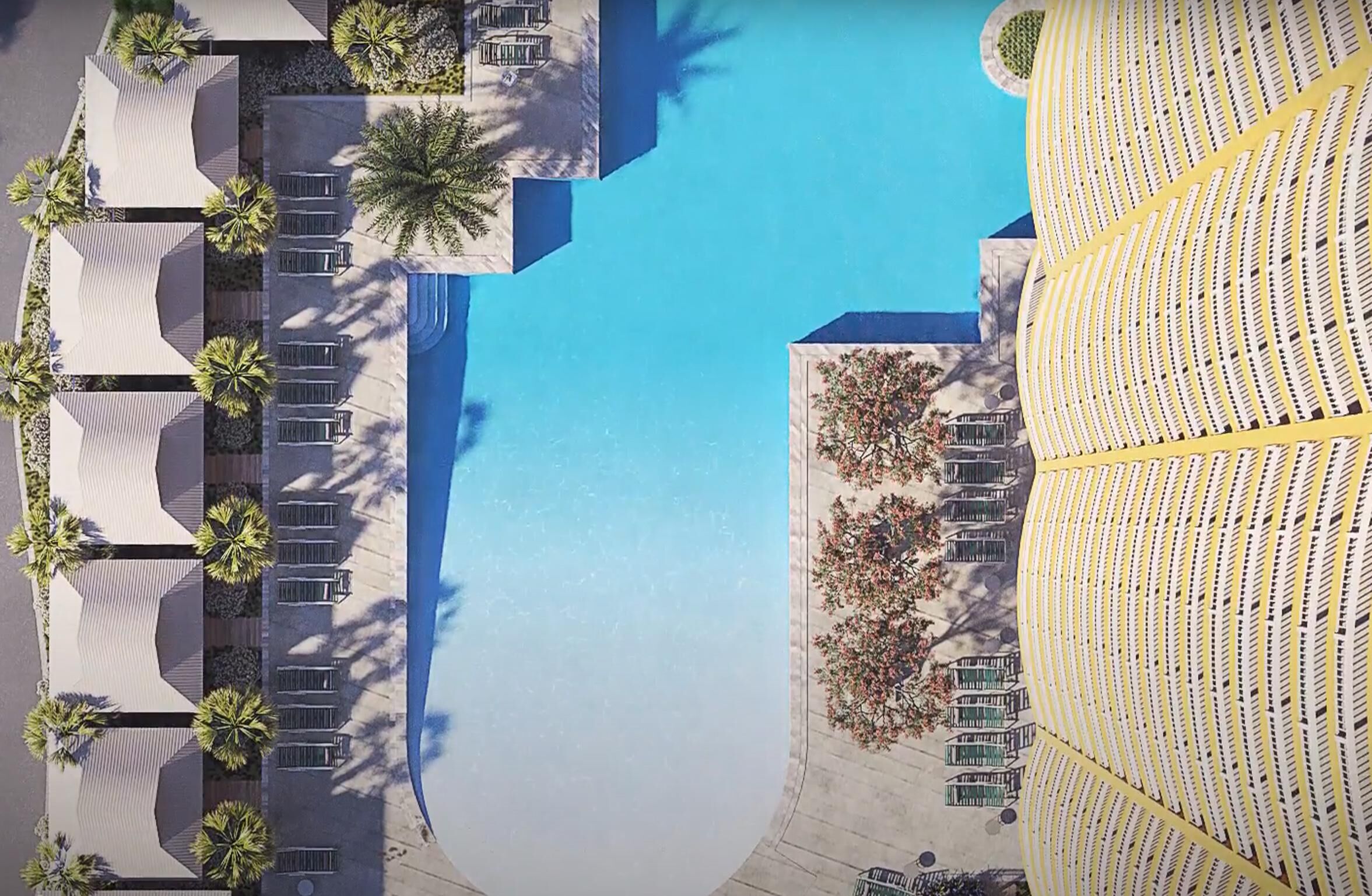 Luchtbeeld van een resort met een groot zwembad, palmbomen en een zitgedeelte.