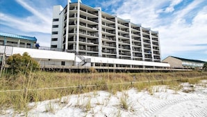 A multi-story hotel with a modern architectural design, featuring balconies and a flat roof. - Aquavista 404e (Panama City Beach)
